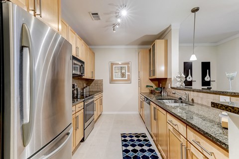 a kitchen with wooden cabinets and stainless steel appliances